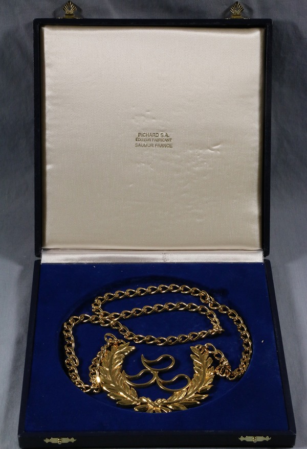 IPC award with gold logo and wreath on chain
