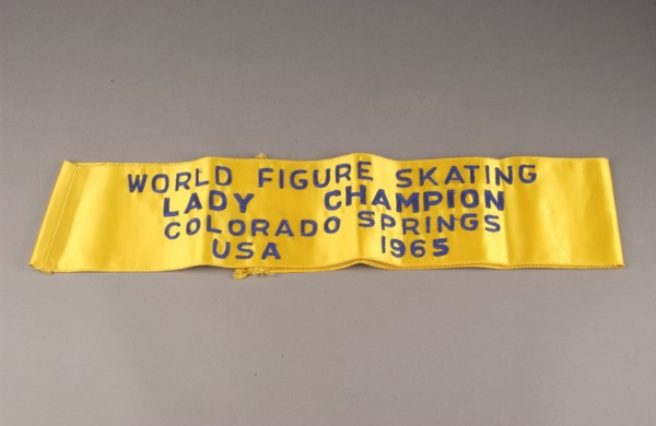 gold sash with World Figuring Skating Lady Champion)