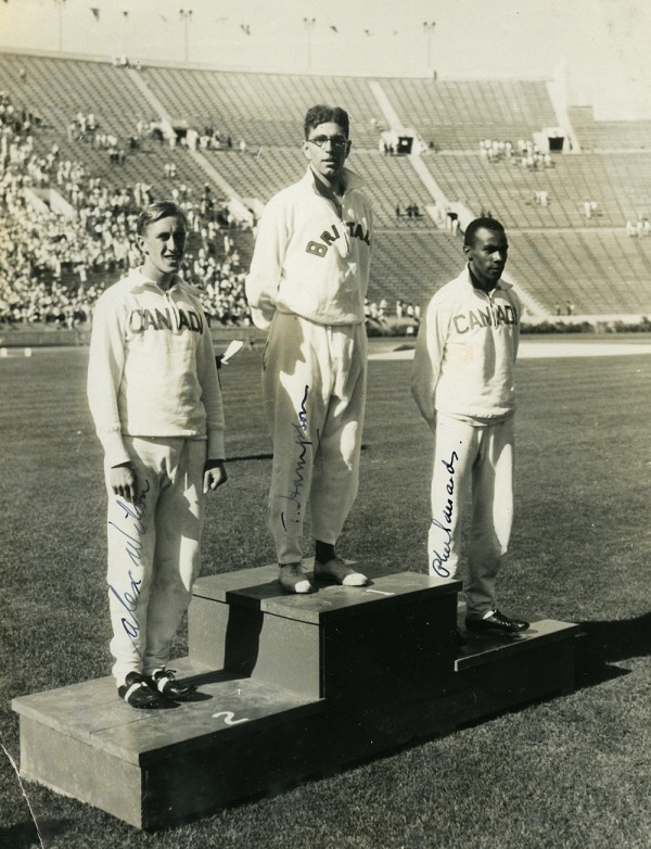 photograph of Phil Edwards on far right on podium