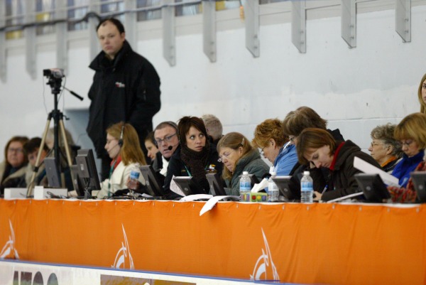 Photograph of figure skating judges at table