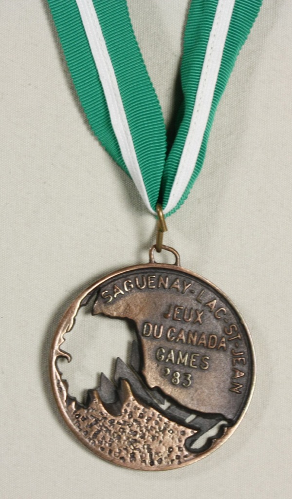 Bronze medal with cut-out on green ribbon