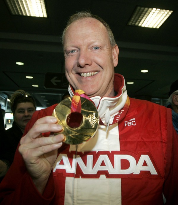 Photograph of Russ Howard holding Olympic Gold medal