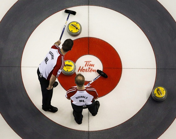 photograph of Brad Gushue and Mark Nicols discussing shot