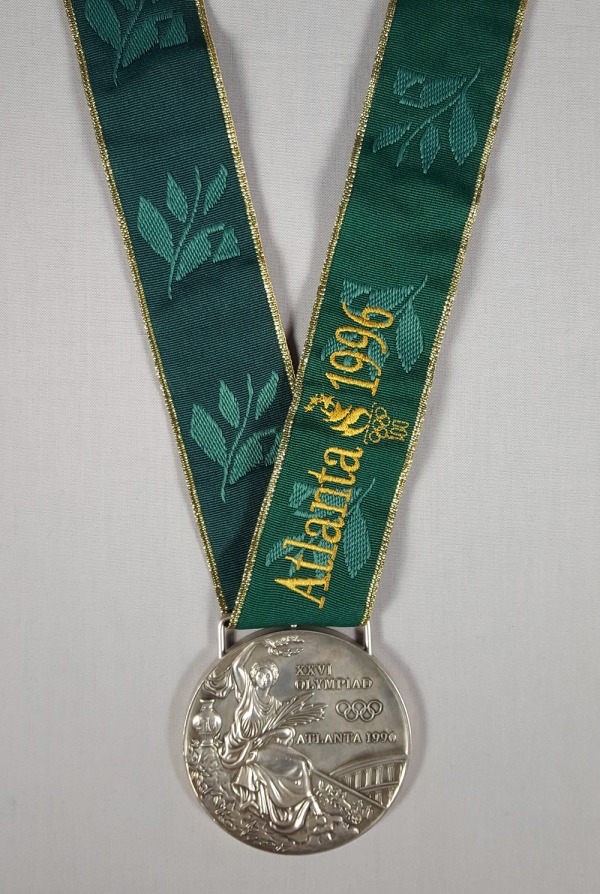 gold medal from the 1996 Olympic Games on green ribbon