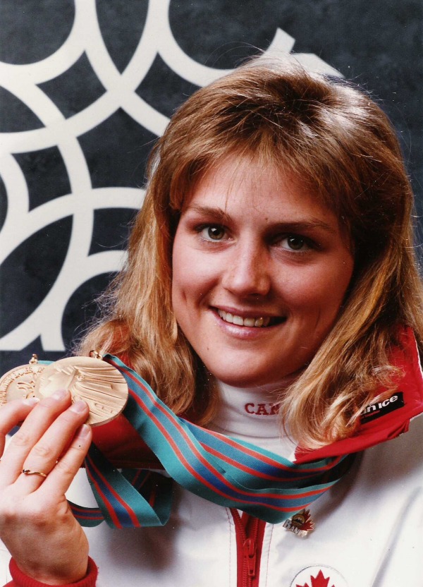 photograph of  Karen Percy holding two Olympic bronze medals