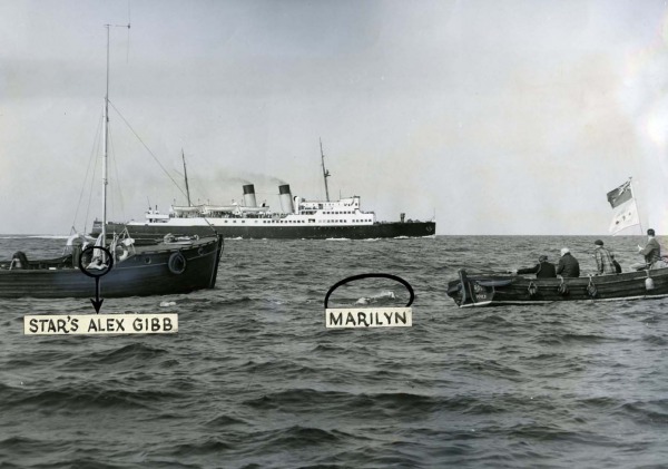 photograph of three boats and swimmer in water marked Star's Alex Gibb and Marilyn