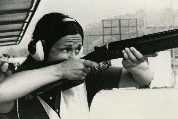 Photograph of Susan Nattrass holding rifle while shooting