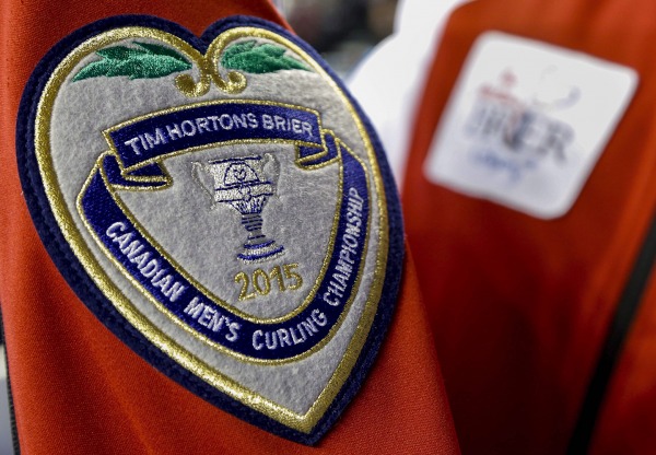 photograph of silver Brier crest on red jacket, crest reads Tim Horton's Brier Canadian Men's Curling Championship 2015
