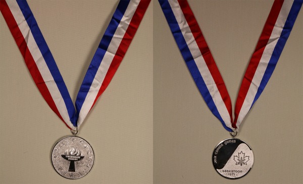 Silver medal on red, white and blue ribbon with maple leaf/snowflake logo