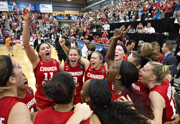 photograph of Canadian women's basketball team celebrating victory
