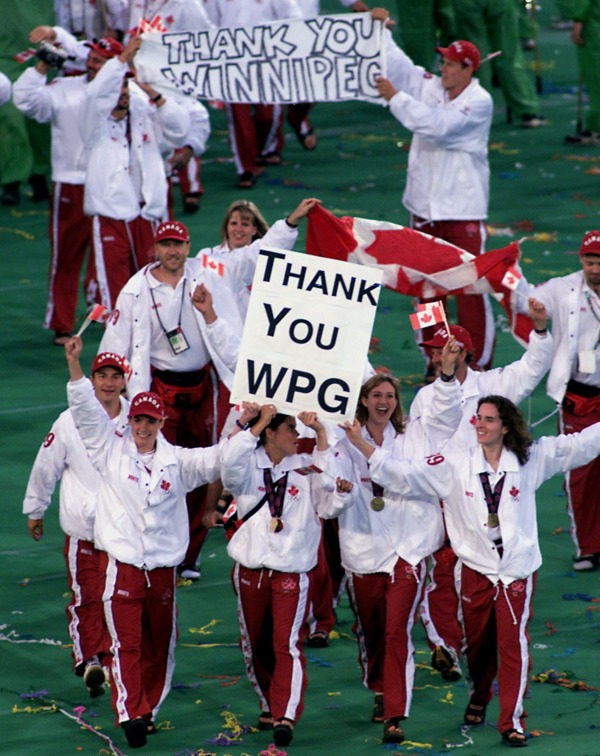 photograph of Canadian athletes with sign Thank You WPG