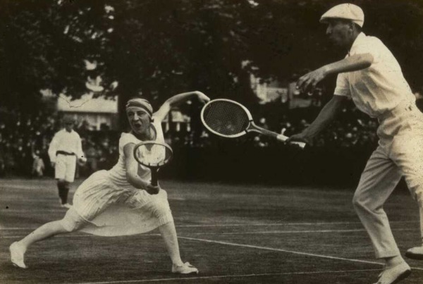woman in white tennis dress playing mixed doubles game