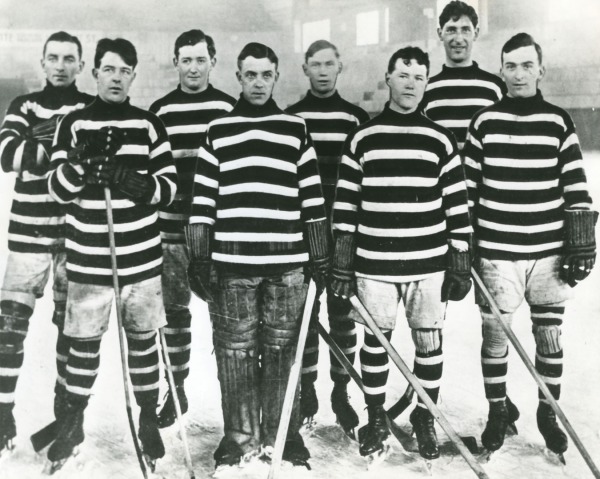 photograph of team wearing black and white striped jerseys