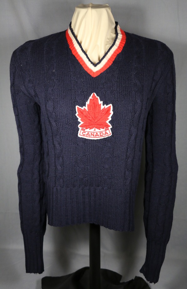 blue wool sweater with red maple leaf crest
