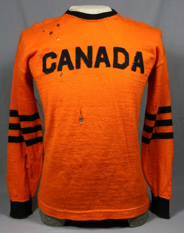 orange football jersey with CANADA in black letters