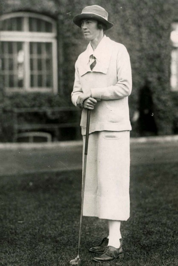 photograph of Ada Mackenzie standing with golf club