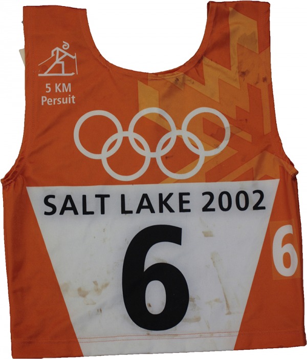 orange race bib with Olympic rings and number 6