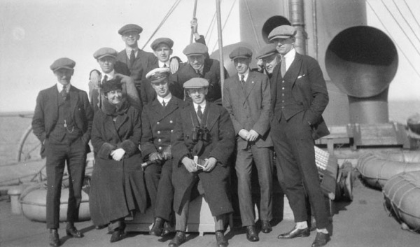 photograph of team members and woman on board ship