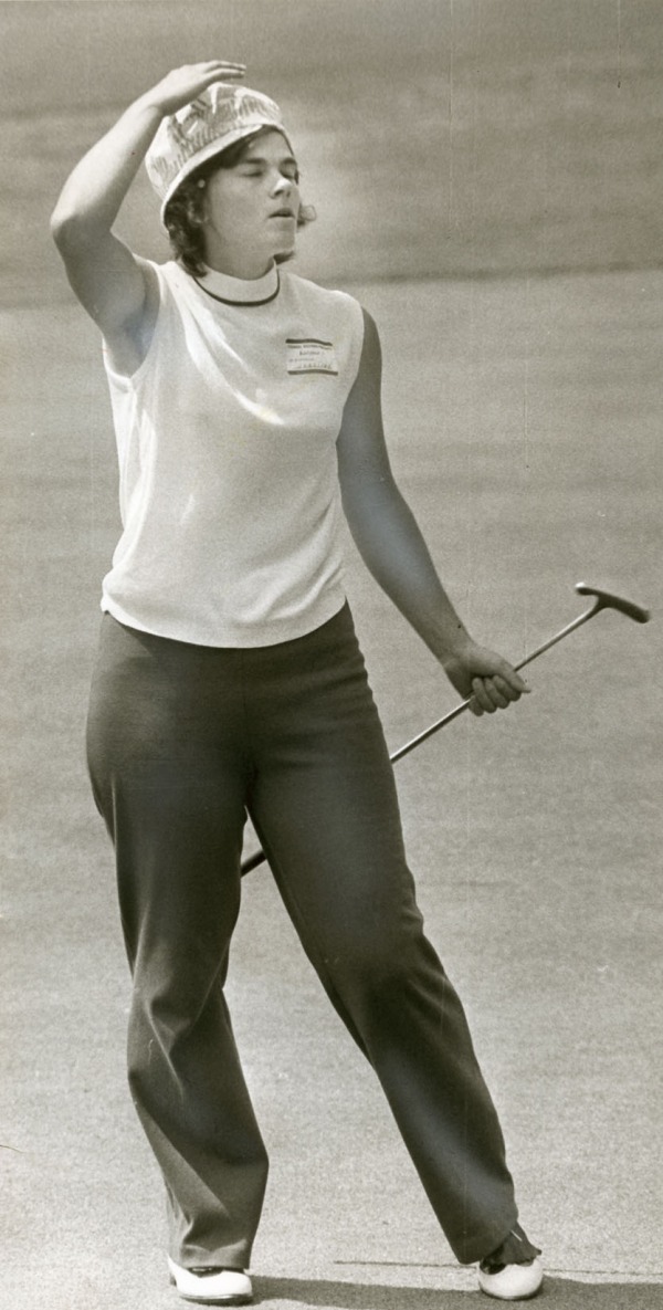 photograph of Jocelyne Bourassa holding golf club on course