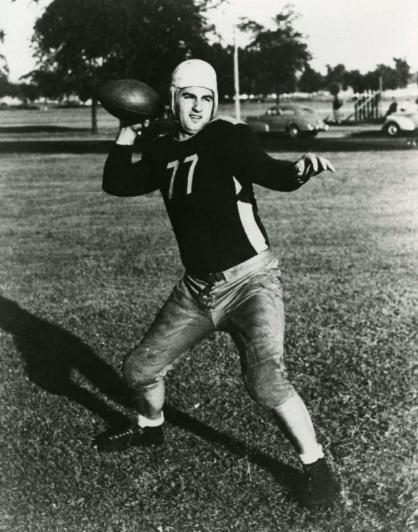 Joe Krol wearing jersey #77 throwing football