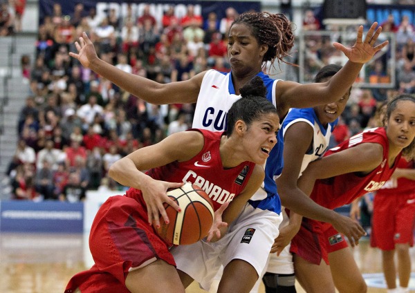 Photograph of Kia Nurse driving past opposition player in basketball game
