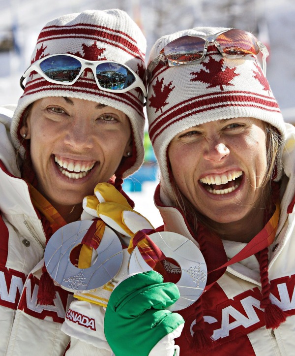 photograph of Beckie Scott and Sara Renner holding silver medals