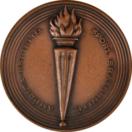 circular bronze medal with torch at centre