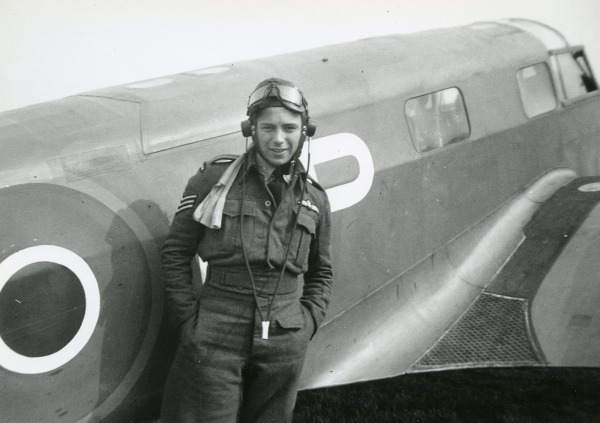 Photograph of Daryl Seaman standing beside an airplane