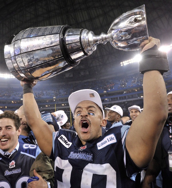 Toronto Argonaut player holds Grey Cup