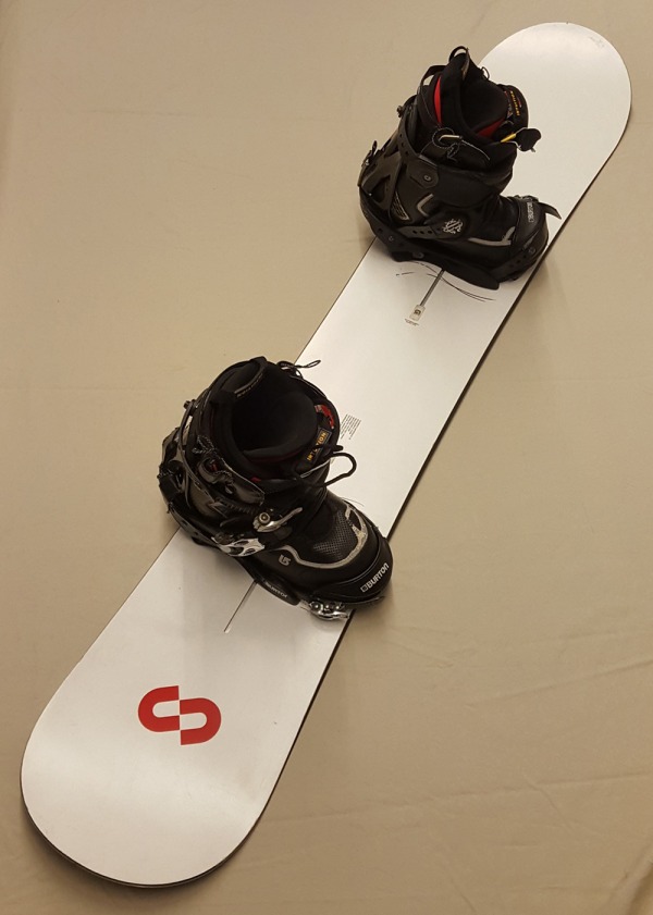 white snowboard with boots attached